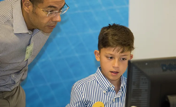 A volunteer mentor working with a student