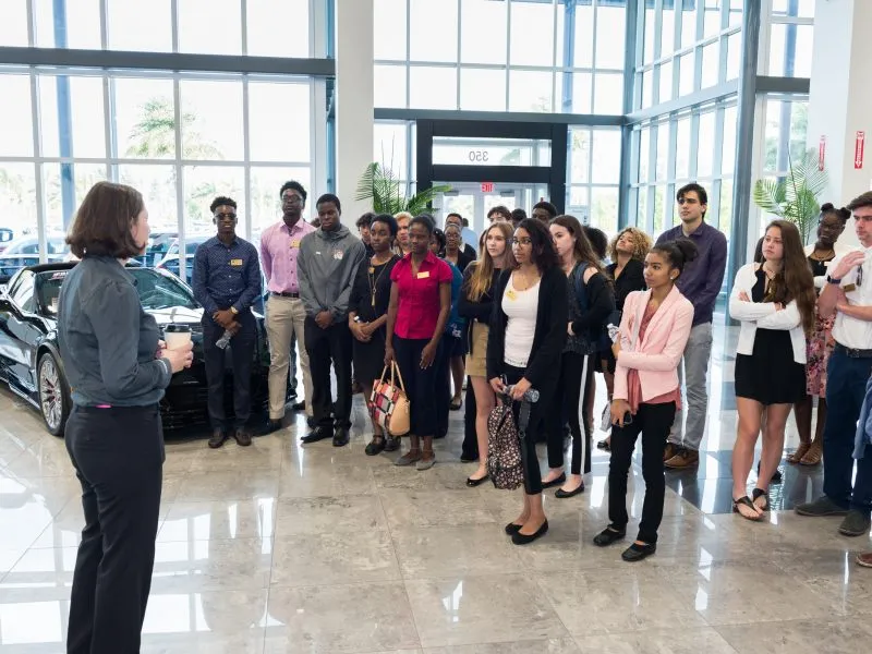 Students on a corporate site visit with a business partner